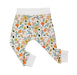 A pair of cuffed pants featuring a comfortable fit with cuffs at the ankles, with pretty colourful flowers and leaves in different colours.
