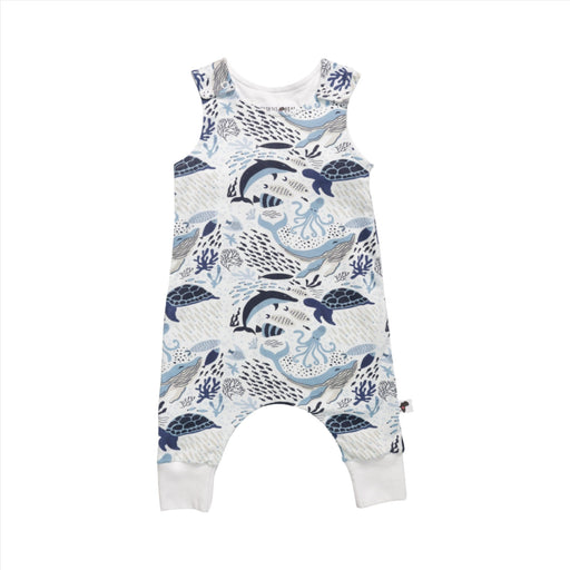 Front of a harem romper with an ocean-themed pattern featuring various sea creatures including whales, dolphins, turtles, and octopuses in shades of blue and white.