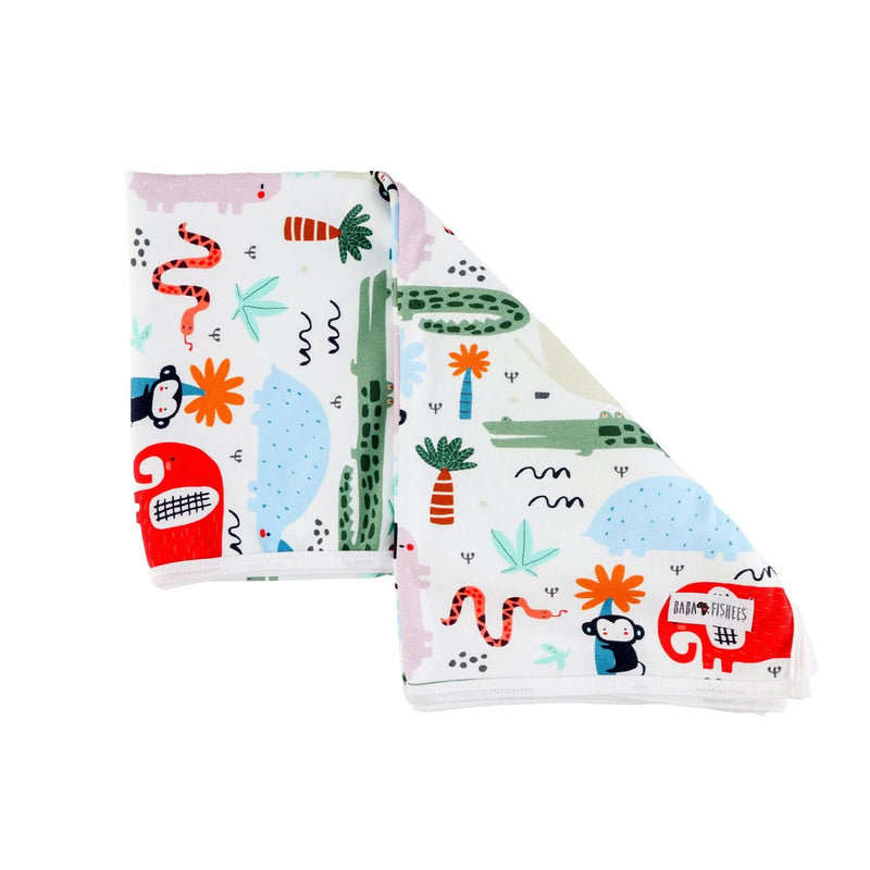 Baby blanket - Rust Ellie featuring vibrant African animal prints, including elephants, crocodiles, monkeys, and plants, on a white cotton background laid out.