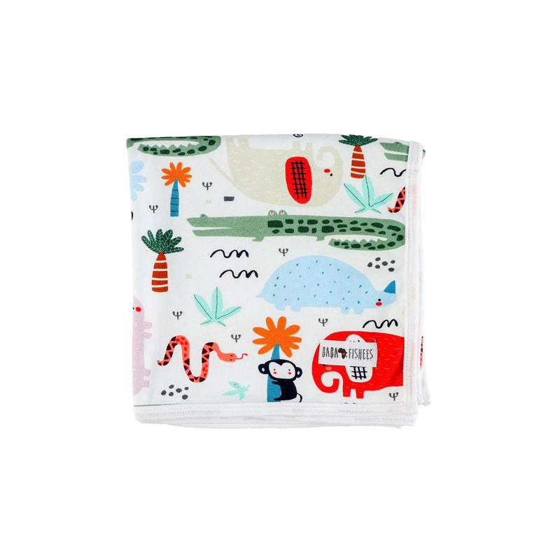 Folded up Baby blanket - Rust Ellie featuring vibrant African animal prints, including elephants, crocodiles, monkeys, and plants, on a white cotton background.