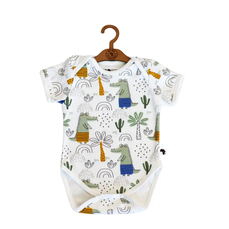 Classic Onesie short sleeve baby onesie in Walking Croc print with green crocodiles, rainbow doodles and palm trees on a white background