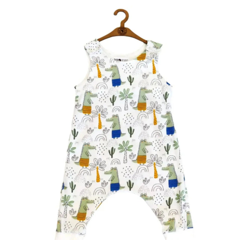 A harem romper featuring cheerful crocodile prints with palm trees and rainbows, crafted for comfort and style, available in sizes 0-24 months.
