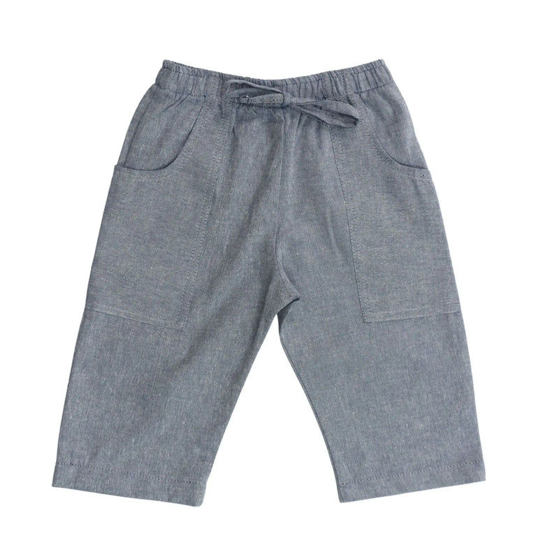 Front view of Relaxed Fit Pants in French Blue cotton chambray with mock tie waistband and long pocket wrapping from side seam to back.