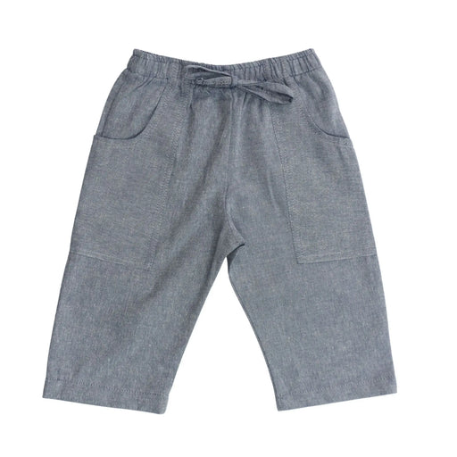 Front view of Relaxed Fit Pants in French Blue cotton chambray with mock tie waistband and long pocket wrapping from side seam to back.