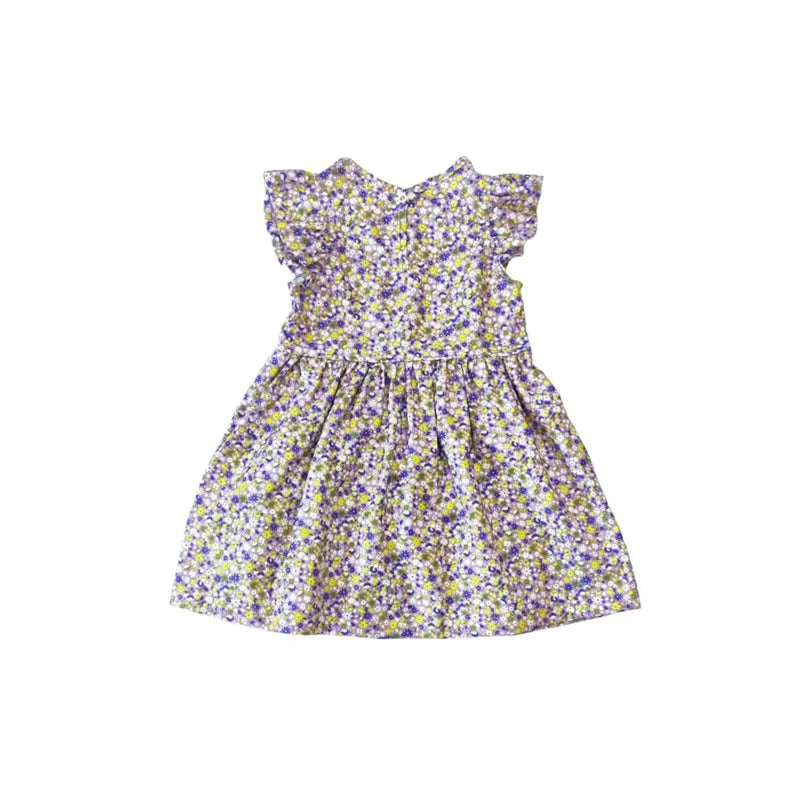 A sleeveless sunflower dress for toddlers featuring a ditsy floral pattern in purple, yellow, and green tones, with flutter sleeves and a gathered waist, crafted from lightweight cotton fabric.
