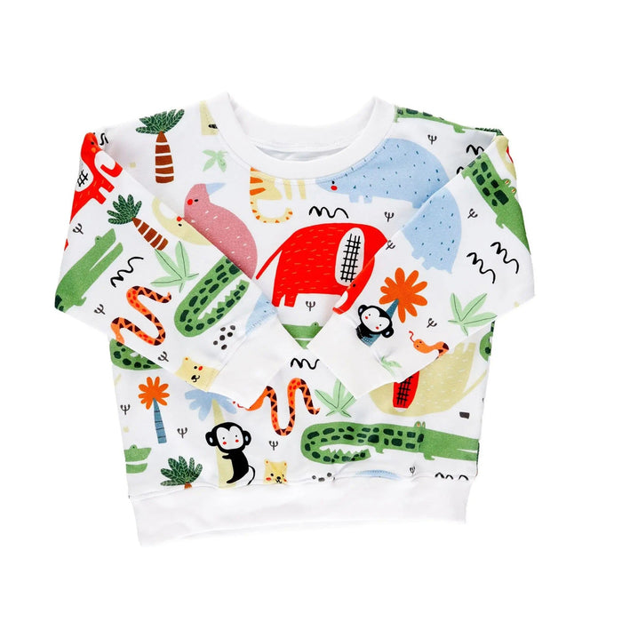 Front view of a sweatshirt with a white background and brightly coloured animals including crocodiles, monkeys, snakes and rust coloured elephants.