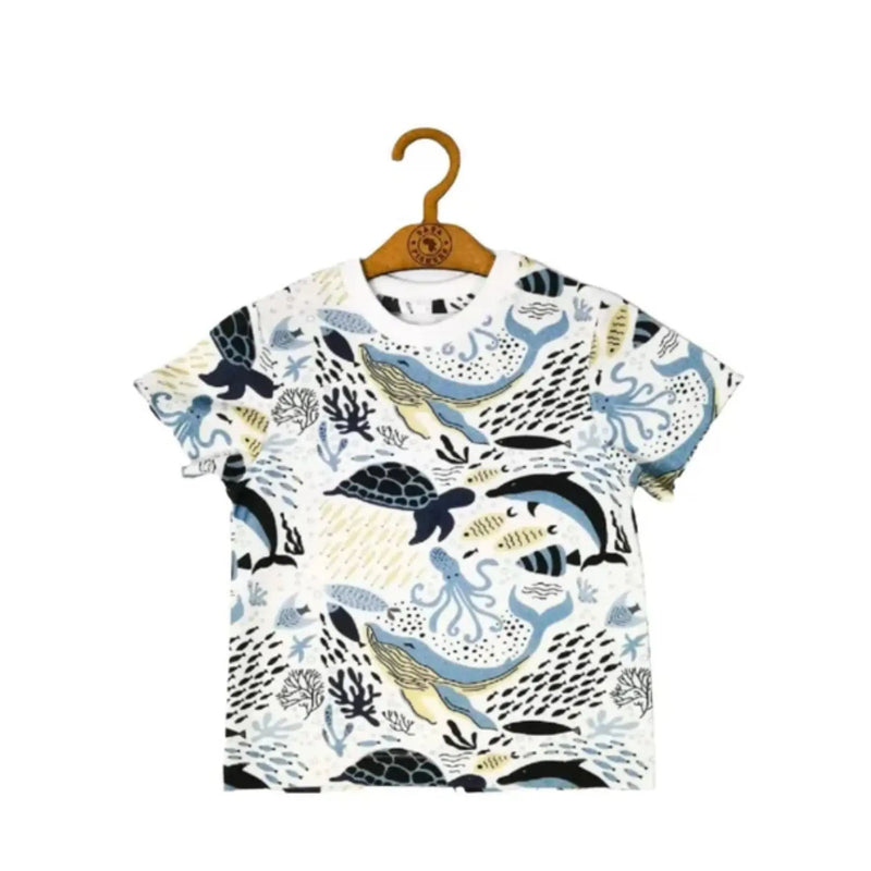 A children’s T-shirt featuring an underwater adventure print with whales, turtles, dolphins, and octopuses, perfect for casual and stylish wear.