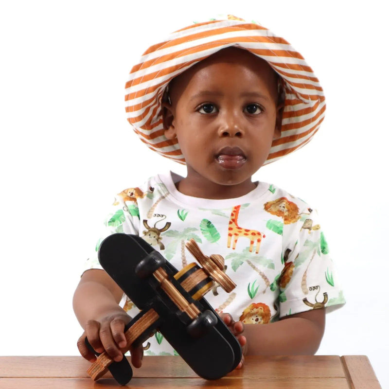 A child wearing a Simba Watercolour print tee shirt and showing the reverse side of the Simba Watercolour Bucket Hat from Baba Fishees.