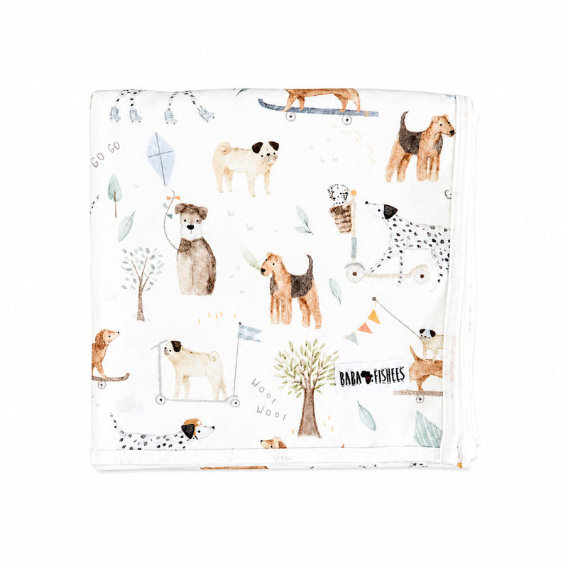 Soft baby blanket made from 100% interlock cotton featuring a playful dog playground print on a white background from Baba Fishees