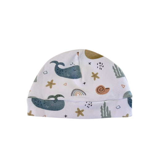 Classic Beanie - Whales on White in white with blue whales, starfish and sea-themed details
