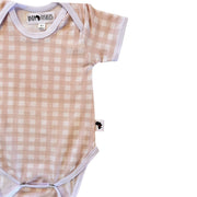 A short-sleeve baby bodysuit with a light pink and white gingham check pattern, featuring white ribbed trim and a visible 'BABA FISHEES' brand label.