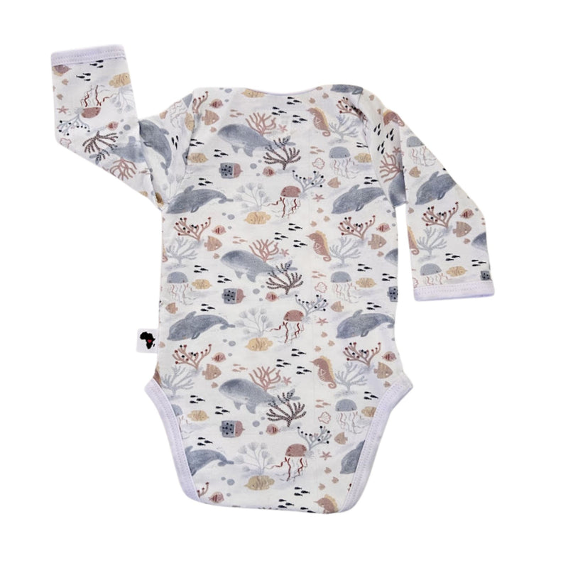 Back view of a white Classic Onesie - Fin and Friends with long sleeves, an envelope neckline and an all-over dolphin, whale, jellyfish, seahorse, fish and coral print