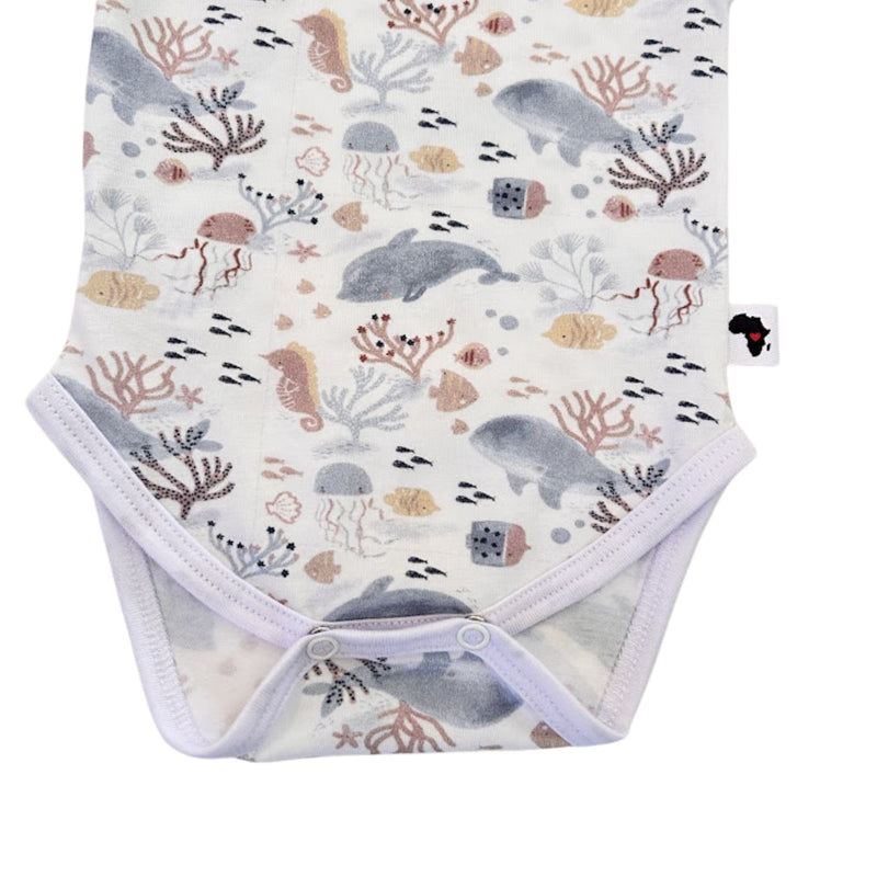 Bottom close-up of long-sleeve Classic Onesie - Fin and Friends showing two crotch press studs, white-bound leg openings and detailed marine illustrations