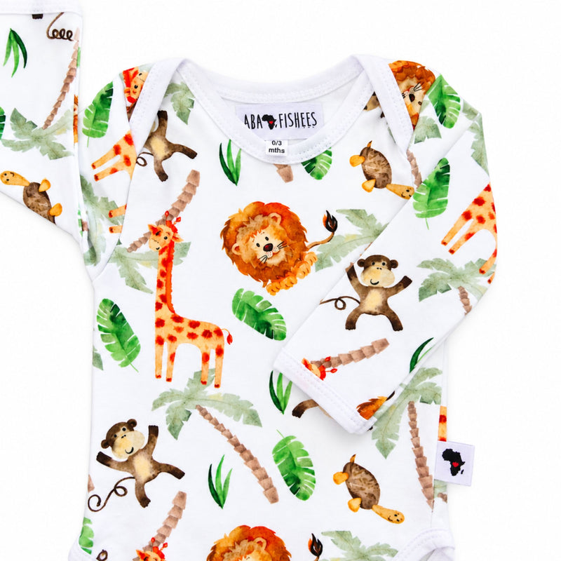 Classic Onesie - Simba Watercolour neckline close-up showing overlapping shoulders, white binding and stitching beside an orange lion, giraffe and brown monkey print.