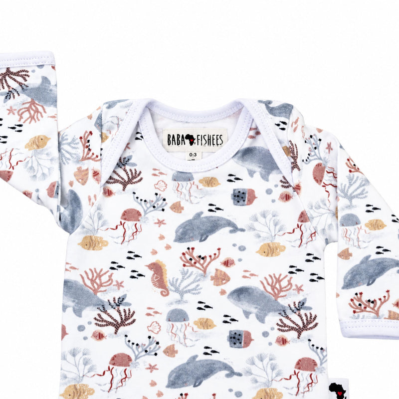 Top close-up of long-sleeve Classic Onesie - Finn and Friends showing the white-bound envelope neckline, long sleeves and Baba Fishees neck label