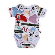 Short-sleeve baby onesie featuring a safari-inspired design with monkeys, crocodiles, snakes, palm trees, and colourful patterns on a white background. Made from a soft cotton-lycra blend with snap closures for easy changes.