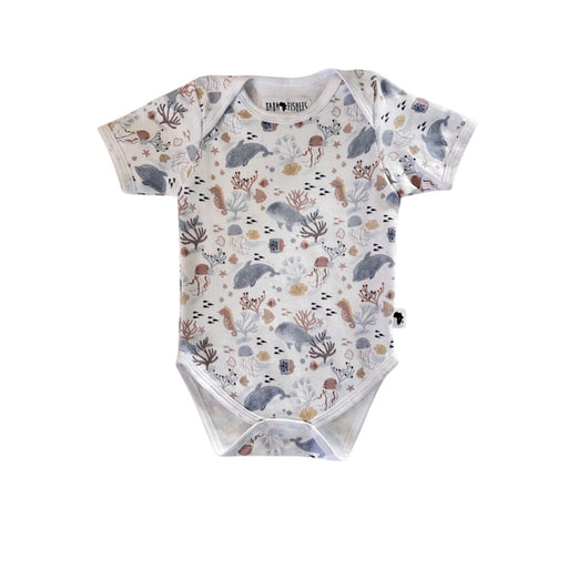 Front view of a white Classic Onesie - Fin and Friends with short sleeves, an envelope neckline and a muted dolphin, whale, jellyfish, seahorse, fish and coral print