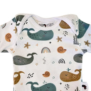 Classic Onesie - Whales on White short-sleeve envelope neckline and whale print close-up