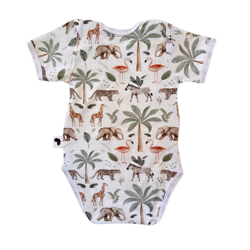 A short-sleeve baby bodysuit with an all-over safari print featuring giraffes, elephants, zebras, palm trees, flamingos, and birds.
