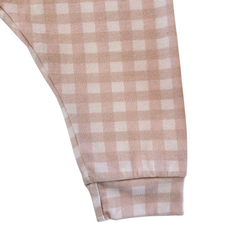 Leg close-up: Close-up of the pink gingham fabric and cuffed ankle on the Comfy Pants - Gingham