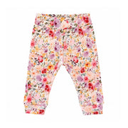 A pair of toddler girls' floral print pants with a high waistband and cuffed ankles, featuring a dense pattern of pink, red, orange, and purple flowers with green leaves on a white background.