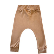Back view of a pair of toddler's cuff pants in a caramel colour, featuring an elastic waistband and ribbed ankle cuffs.
