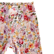 Side view of Cuff Pants - Floral Fantasy with pink, purple and orange floral print and cuffed ankles