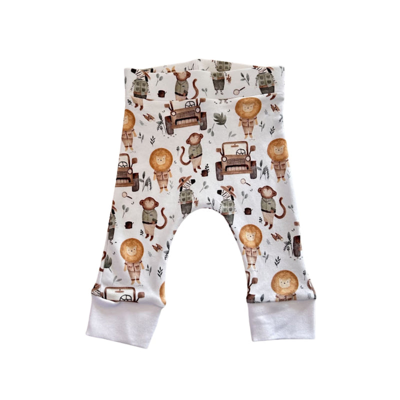 Front view of off-white Cuff Pants - Jeep Safari with lions, monkeys, zebras and vintage safari jeep print
