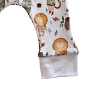 Close-up of Jeep Safari cuff pants fabric showing lion print and soft white ankle cuff