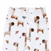 Close-up of Footy Pants in the Kameelperd print, showing the wide white fabric waistband, neat centre seam and detailed brown and beige giraffes.