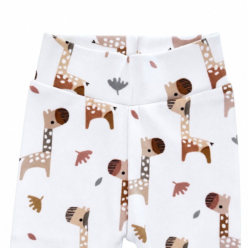 Close-up of Footy Pants in the Kameelperd print, showing the wide white fabric waistband, neat centre seam and detailed brown and beige giraffes.
