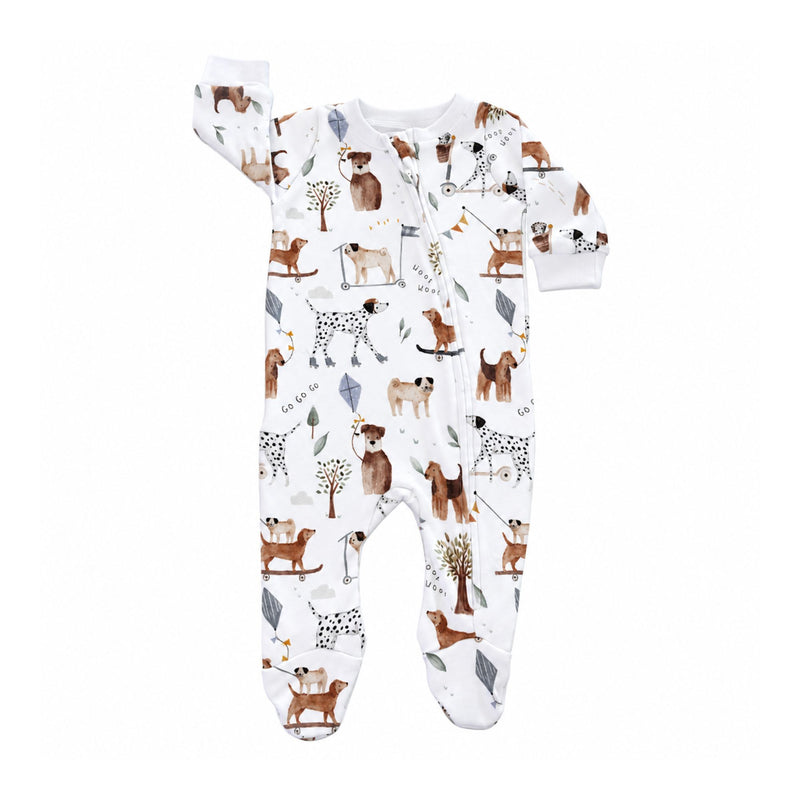 Front view of the white Footy Romper - Dogs Playground, featuring colourful dogs on scooters, skateboards and roller skates, long sleeves, a full-length zip and built-in footies.