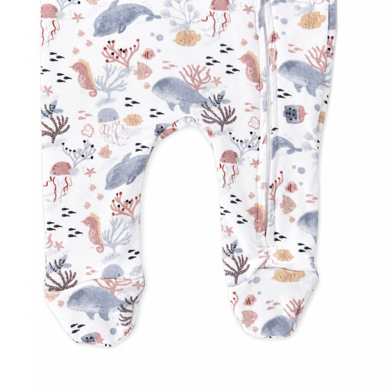 Finn and Friends footy romper leg detail showing enclosed printed feet, zip along one leg and blue-grey dolphins, pink seahorses and golden fish on white.