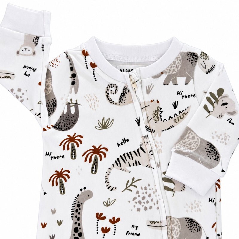 Footy Romper - Hi There White, close-up of the white neckline, zip cover and sleeve cuffs with animal motifs and rust palm trees.