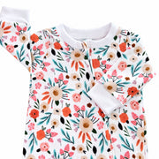 Close-up of the Oh So Pretty Footy Romper neckline, showing the white ribbed trim, concealed full-length zip and detailed coral, peach, blush and aqua floral print.