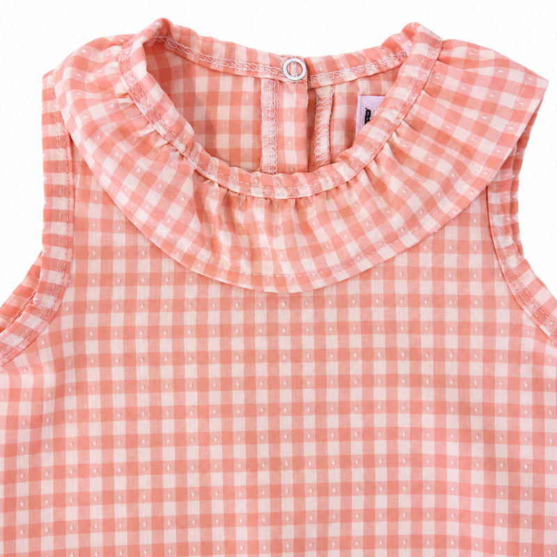 Close-up of the peach gingham Frilly Neck Romper’s gathered frill collar, showing the bound neckline, white stitching and delicate dotted fabric texture.