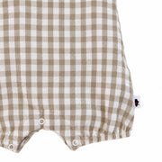 Frilly Neck Romper Gingham - Stone lower detail, showing three white crotch press studs, elasticated leg hems, curved seam stitching and side brand label.