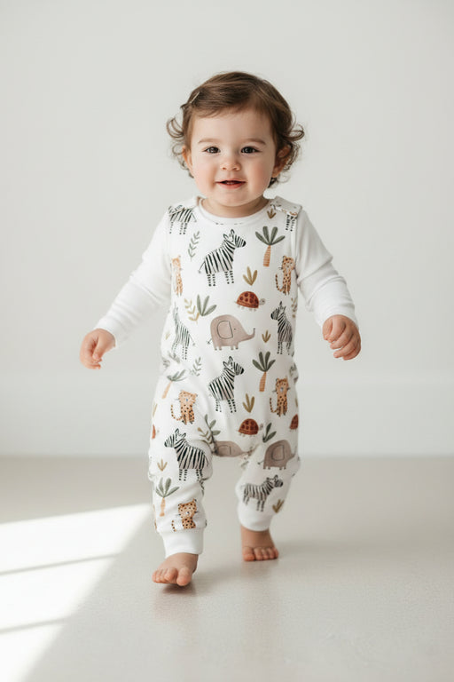 White baby harem romper with Zebra Party safari print featuring zebras, elephants, cheetahs, tortoises and leafy details