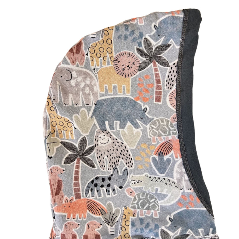 A close-up of a fabric hood featuring a colorful safari animal print on a muted blue-gray background, with a solid airforce blue side panel.