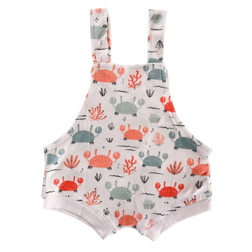Back view of Knot Dungaree - Crab Gang in white background with pink and pale blue crabs print, sea-inspired details and knot shoulder straps