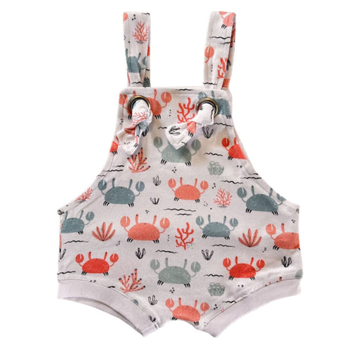 Knot Dungaree - Crab Gang in white background with pink and pale blue crabs print, sea-inspired details and knot shoulder straps