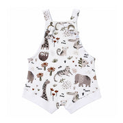 Knot Dungaree - Hi There White, front view with knotted straps through metal eyelets, white leg cuffs and beige animals among olive leaves and rust palms.