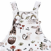 Knot Dungaree - Hi There White, bib-front detail showing fabric knots through two metal eyelets, neat stitching and giraffe, crocodile, monkey and sloth motifs.