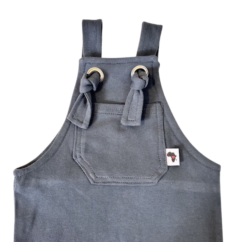 Close up of an Airforce Blue Knot Dungaree Long Leg with adjustable shoulder straps, metal grommets, and a small Baba Fishees label on the chest pocket.