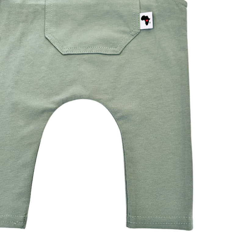 Leg closeup view of  Knot Dungaree Long Leg in Mint Green with  a small Baba Fishees label on the chest pocket.