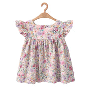 Floral dress on a wooden hanger against a white background