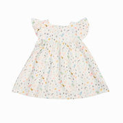 Mocca dress with a tweety bird print in pastel colours on a white background