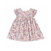 White floral dress with pink, red, purple, blue and yellow flowers, green foliage, flutter sleeves, a round neckline and a gathered, flared skirt.