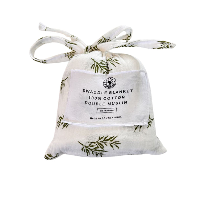 Front view of Swaddle Blanket - Wild Olive presented in a matching white muslin drawstring bag with olive-green botanical branches and fabric ties