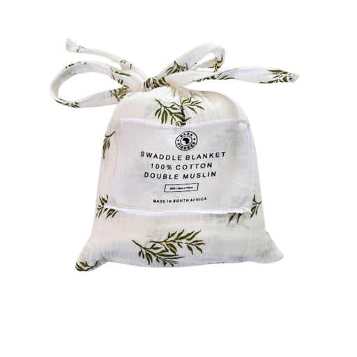 Front view of Swaddle Blanket - Wild Olive presented in a matching white muslin drawstring bag with olive-green botanical branches and fabric ties